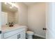 Clean bathroom with vanity, mirror, commode and decorative dark tile flooring at 4810 Floydwood Ln, Mableton, GA 30126