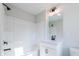 Bright white bathroom features a shower-tub combo with sleek, modern fixtures at 4810 Floydwood Ln, Mableton, GA 30126