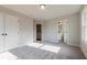 Spacious bedroom featuring soft carpet, natural light, and ample space, creating a comfortable and versatile living area at 4810 Floydwood Ln, Mableton, GA 30126