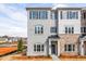 New two-story townhome featuring a gray painted brick facade and dark shutters at 4810 Floydwood Ln, Mableton, GA 30126