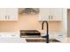 Modern kitchen features white cabinets, stainless appliances, and quartz countertops at 4810 Floydwood Ln, Mableton, GA 30126