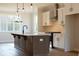 This modern kitchen features a central island, stainless appliances, and stylish pendant lighting at 4810 Floydwood Ln, Mableton, GA 30126