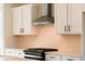 The kitchen features white cabinets and tile backsplash, complemented by modern stainless appliances at 4810 Floydwood Ln, Mableton, GA 30126