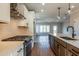 Modern kitchen boasts stainless appliances, granite counters, and a stylish island, offering ample space and contemporary design at 4810 Floydwood Ln, Mableton, GA 30126