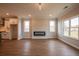 Spacious living room with hardwood floors, modern fireplace, and view of the kitchen at 4810 Floydwood Ln, Mableton, GA 30126