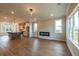 Open-concept living space with hardwood floors, electric fireplace, and abundant natural light at 4810 Floydwood Ln, Mableton, GA 30126
