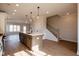 Open concept living spaces features island with bar seating, and adjacent stairway access to upper level at 4810 Floydwood Ln, Mableton, GA 30126
