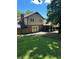 Backyard featuring a grassy lawn, privacy fence, brick patio, and a covered porch at 7310 Ne Wynhill Ne Dr, Atlanta, GA 30328