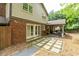 Expansive backyard featuring a covered patio, stone pavers, and lush greenery, perfect for outdoor living and entertaining at 7310 Ne Wynhill Ne Dr, Atlanta, GA 30328