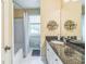 Cozy bathroom with tub, shower, and granite countertop vanity at 7310 Ne Wynhill Ne Dr, Atlanta, GA 30328