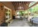 Inviting covered patio with ceiling fan, stone floor, outdoor dining area, and grill, perfect for outdoor gatherings at 7310 Ne Wynhill Ne Dr, Atlanta, GA 30328