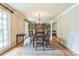 Formal dining room with hardwood floors, elegant chandelier, and large windows for natural light at 7310 Ne Wynhill Ne Dr, Atlanta, GA 30328