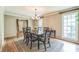 Traditional dining room with hardwood floors, decorative rug, and large windows at 7310 Ne Wynhill Ne Dr, Atlanta, GA 30328