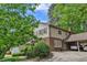 Rear exterior view of home with brick and siding, carport with 2 parked cars at 7310 Ne Wynhill Ne Dr, Atlanta, GA 30328