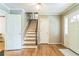 Inviting foyer features hardwood floors and staircase with white trim, leading to the upper level at 7310 Ne Wynhill Ne Dr, Atlanta, GA 30328