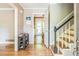 Welcoming foyer featuring a view into the kitchen and wooden staircase with black railing at 7310 Ne Wynhill Ne Dr, Atlanta, GA 30328