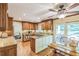 Elegant kitchen with wooden cabinetry, granite countertops, and an island with a cooktop at 7310 Ne Wynhill Ne Dr, Atlanta, GA 30328