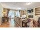 Bright living room with a fireplace, built-in shelving, and French doors leading to the backyard at 7310 Ne Wynhill Ne Dr, Atlanta, GA 30328