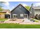 Charming backyard with stone patio, dining set, lush lawn, and stylish gray siding at 2407 Boulder Se Rd, Atlanta, GA 30316