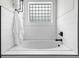 Bright bathroom featuring a soaking tub with white subway tile and a window for natural light at 2407 Boulder Se Rd, Atlanta, GA 30316