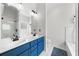 Bright Primary bathroom with double vanity, sleek mirrors, shower, and soaking tub at 2407 Boulder Se Rd, Atlanta, GA 30316