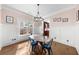 This charming dining room has hardwood floors, wainscoting, and a modern chandelier at 2407 Boulder Se Rd, Atlanta, GA 30316