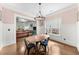 This sunlit dining room has wood floors, a modern chandelier, and charming millwork at 2407 Boulder Se Rd, Atlanta, GA 30316