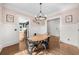 Charming dining room with pink walls, modern chandelier, wood floors, and wainscoting at 2407 Boulder Se Rd, Atlanta, GA 30316