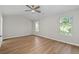 Bright bedroom featuring wood flooring, two windows, and neutral paint at 3253 Strathmore Dr, Duluth, GA 30096
