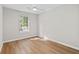 Bedroom with wood flooring, ceiling fan, and a large window letting in natural light at 3253 Strathmore Dr, Duluth, GA 30096