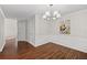 Dining room featuring decorative moldings, chandelier, wood floors, and ample space at 3253 Strathmore Dr, Duluth, GA 30096