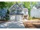Charming two-story home with a two-car garage, lush landscaping, and delightful blue shutters at 3253 Strathmore Dr, Duluth, GA 30096