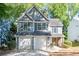 Charming two-story home with a two-car garage, fresh landscaping, and delightful blue shutters at 3253 Strathmore Dr, Duluth, GA 30096