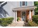 Inviting front entrance featuring a brick facade, charming columns, and a welcoming floral wreath at 3253 Strathmore Dr, Duluth, GA 30096