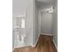 Upstairs hallway featuring wood floors, neutral paint, and natural light at 3253 Strathmore Dr, Duluth, GA 30096