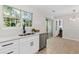 Bright kitchen with stainless steel dishwasher, ample counter space, and a view to the backyard at 3253 Strathmore Dr, Duluth, GA 30096