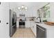 Modern kitchen featuring stainless steel appliances, white cabinets, and a stylish faucet at 3253 Strathmore Dr, Duluth, GA 30096
