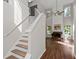 Elegant staircase leading to the upper level, with views of the bright living room and fireplace at 3253 Strathmore Dr, Duluth, GA 30096