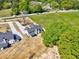 Aerial shot showcasing this home's generous lot, long drive, and proximity to a tree-lined street at 3132 Rosebud Rd, Loganville, GA 30052