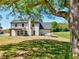 View of home's back exterior featuring covered patio, spacious yard and well maintained lawn at 3132 Rosebud Rd, Loganville, GA 30052