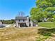 Back of two-story home featuring a covered patio and spacious yard at 3132 Rosebud Rd, Loganville, GA 30052
