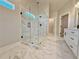 Bright bathroom features frameless glass shower, modern fixtures, large mirror, and tile floor at 3132 Rosebud Rd, Loganville, GA 30052