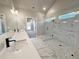 Bright bathroom with double vanity, frameless glass shower, modern fixtures, and marble look tile floor at 3132 Rosebud Rd, Loganville, GA 30052