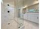 Bright bathroom features double vanity, modern fixtures, frameless glass shower, and tile floor at 3132 Rosebud Rd, Loganville, GA 30052
