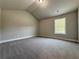 Carpeted bedroom offering natural light from window and neutral color palette at 3132 Rosebud Rd, Loganville, GA 30052