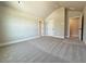 A carpeted bedroom offering a neutral palette, doors, and good natural light at 3132 Rosebud Rd, Loganville, GA 30052
