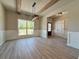 Open concept dining area boasts wood beam ceiling, a modern light fixture, and large windows at 3132 Rosebud Rd, Loganville, GA 30052