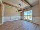 Bright dining room with wood beam ceiling, modern light fixture, and large window with outdoor views at 3132 Rosebud Rd, Loganville, GA 30052