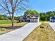 New construction home featuring a long driveway and an inviting two-story façade and three car garage at 3132 Rosebud Rd, Loganville, GA 30052