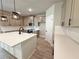 Beautiful kitchen with a large island, stainless appliances, and modern pendant lighting at 3132 Rosebud Rd, Loganville, GA 30052